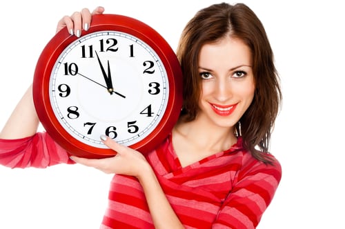 Woman holding a clock signifies Many people with ADHD or Aspergers have trouble managing their time because they have trouble being present in the moment.