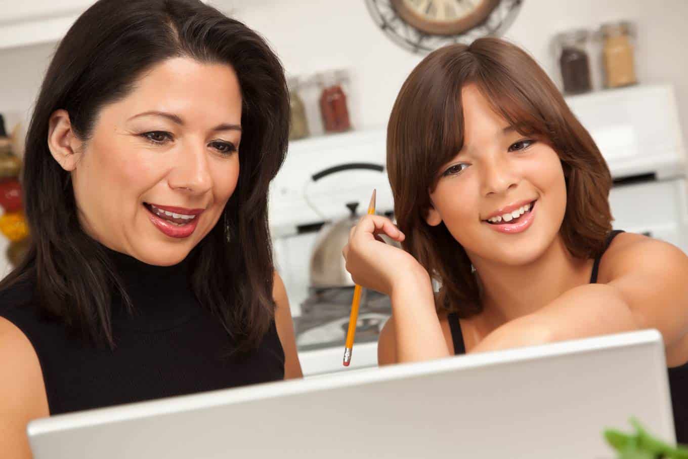 Mom and daughter looking at computer together