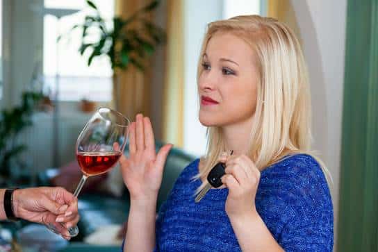 Woman declining a glass of wine