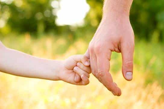 Child holding parent's hand