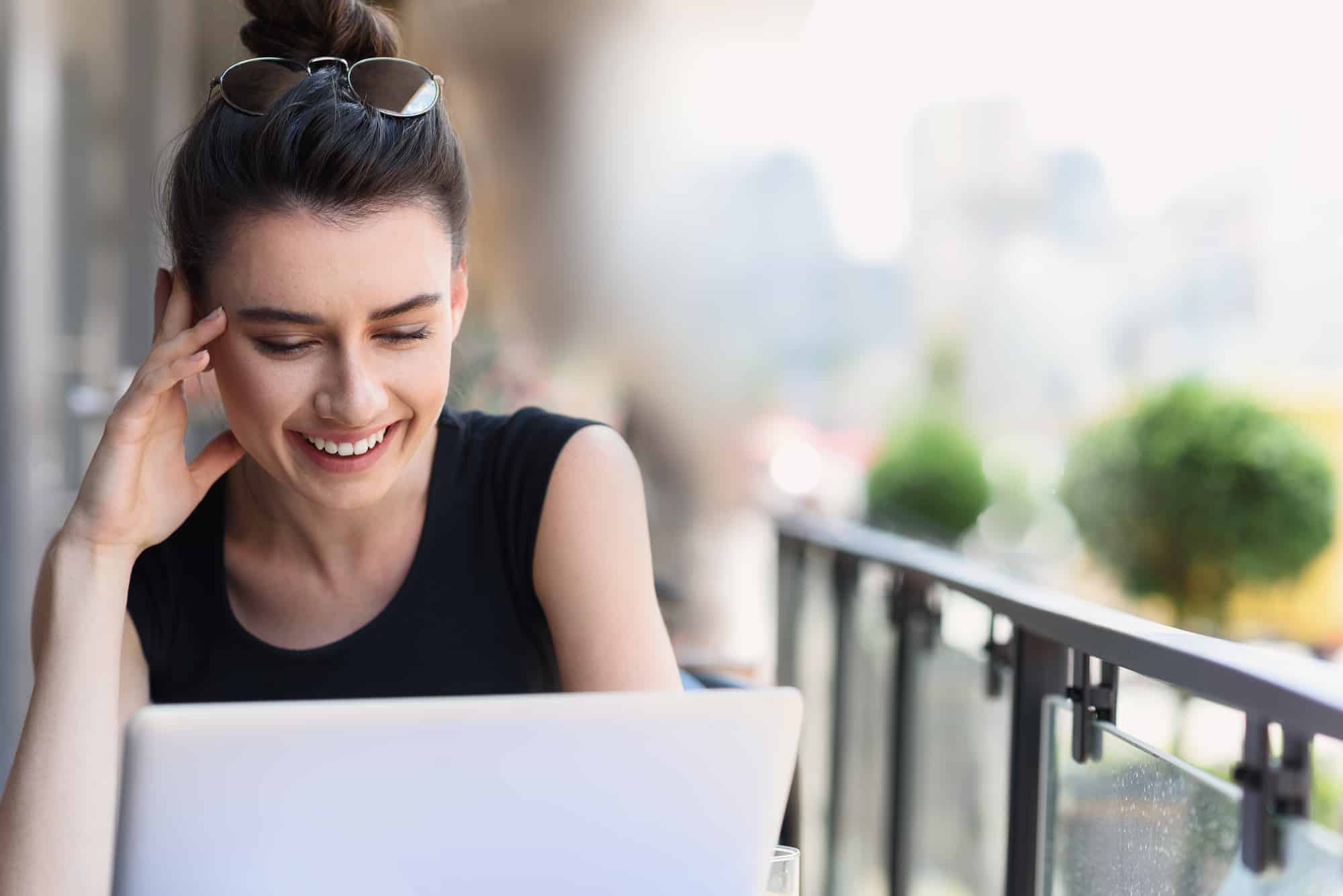 Woman smiling and looking at computer screen